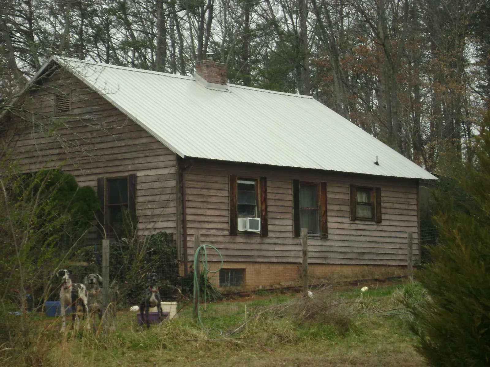White metal roof on an old wood sided farmhouse, from a Metal Roof Installation job in West Mifflin